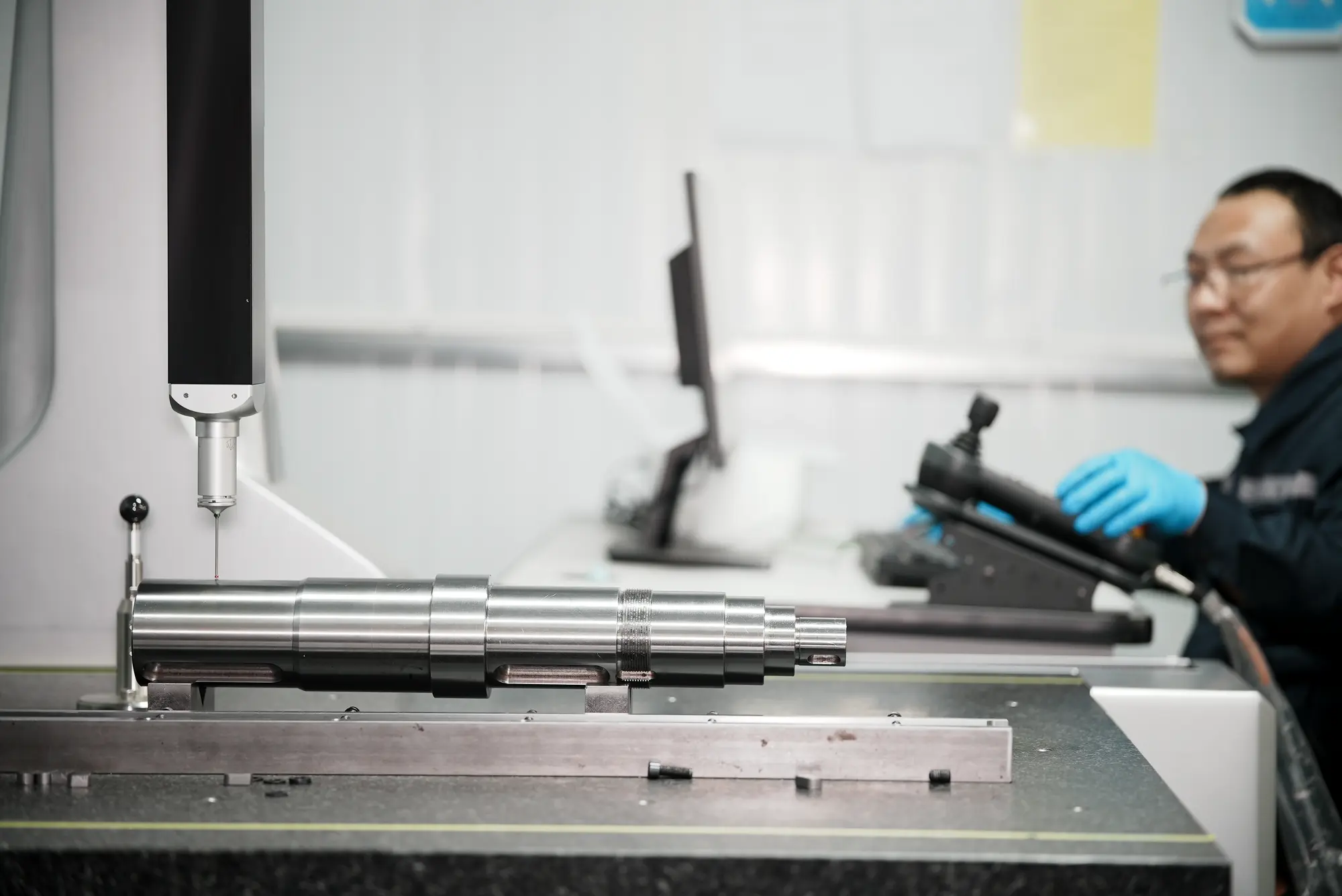 Precision shaft undergoing dimensional inspection on a coordinate measuring machine